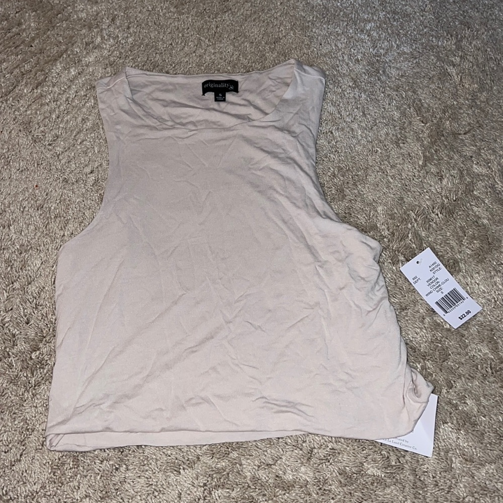 I’m selling a cream flowy tank top